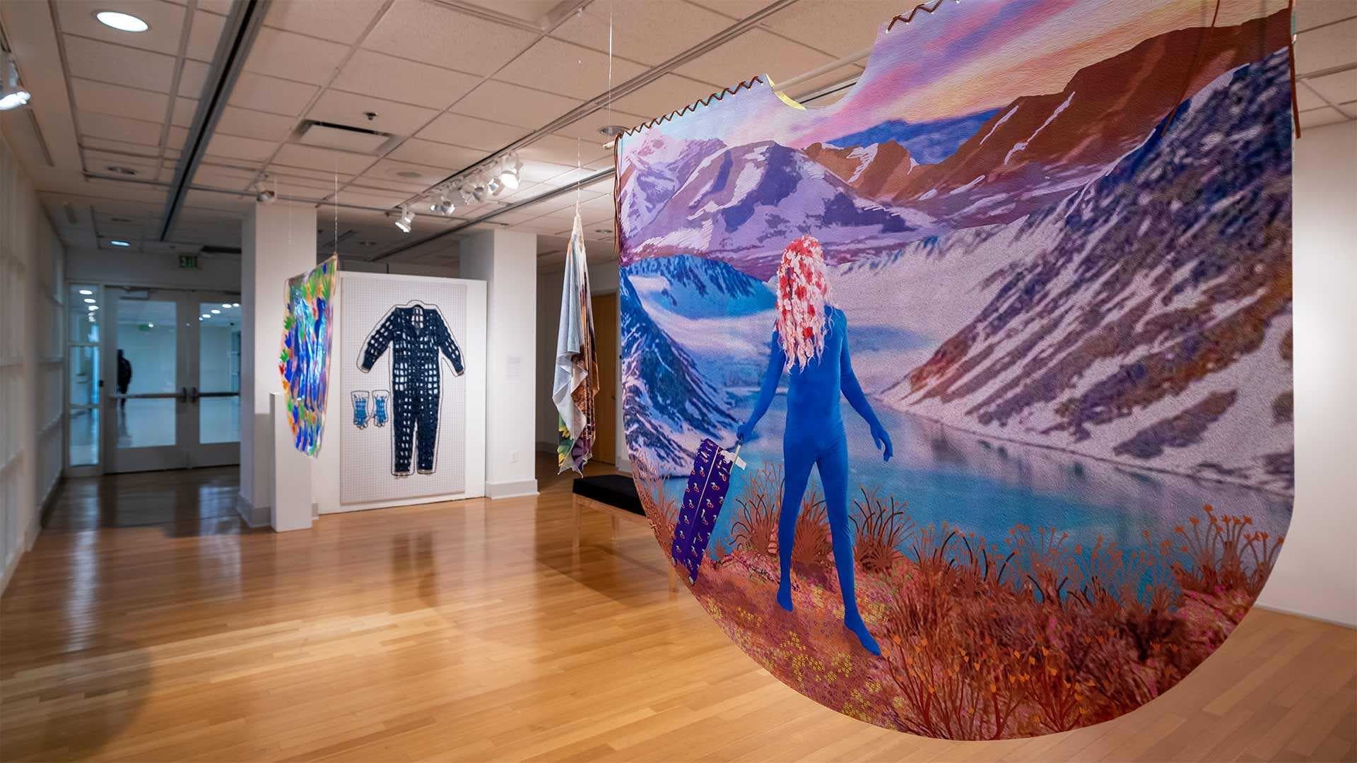 art hangs in "Unfold" exhibit in Stamp Gallery