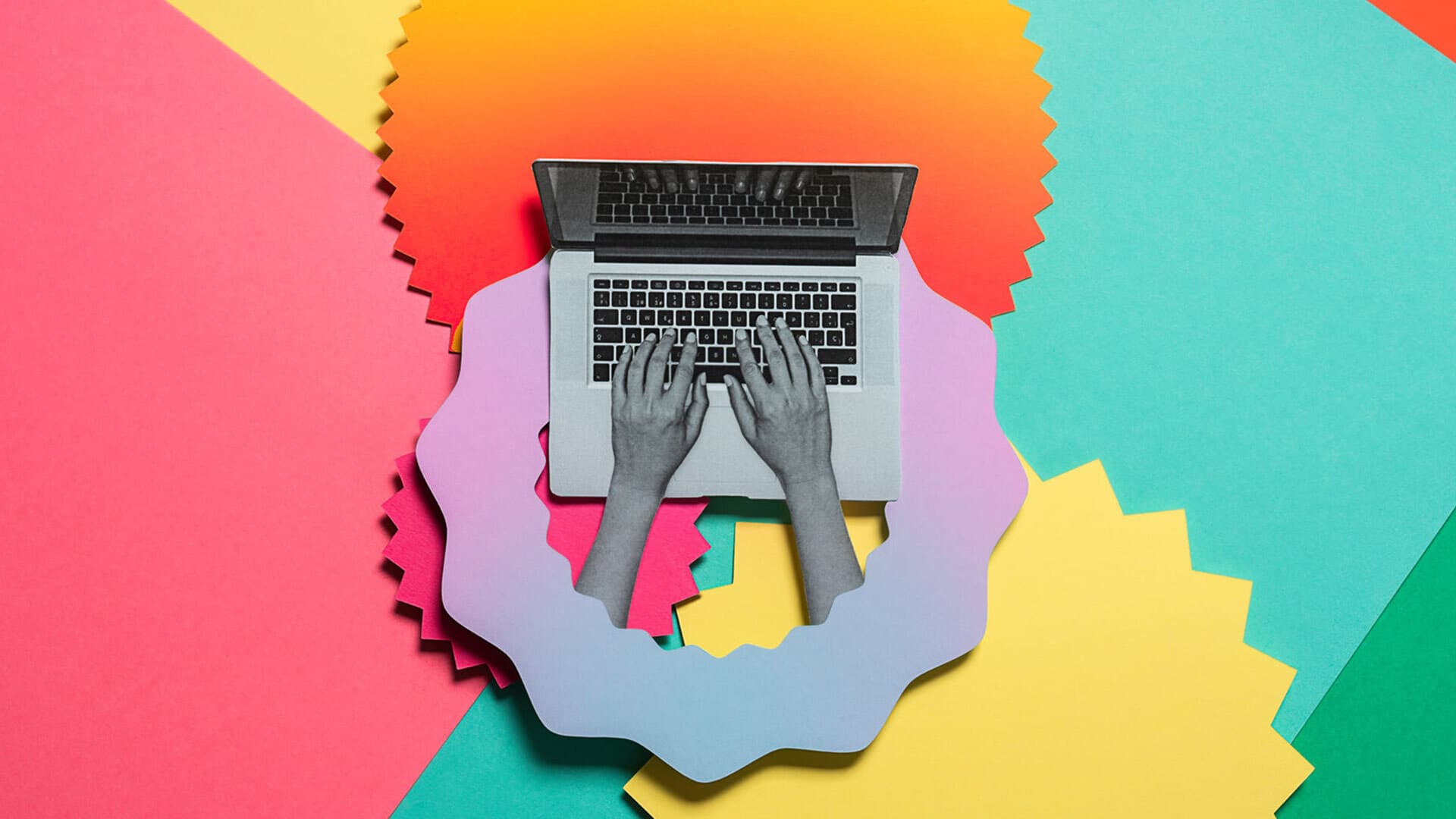 Hands typing on a laptop on a colorful background