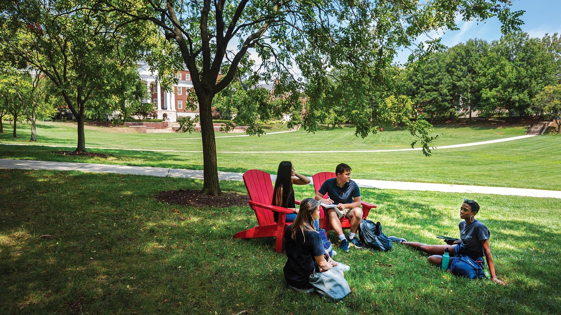 Students sitting outdoors on campus