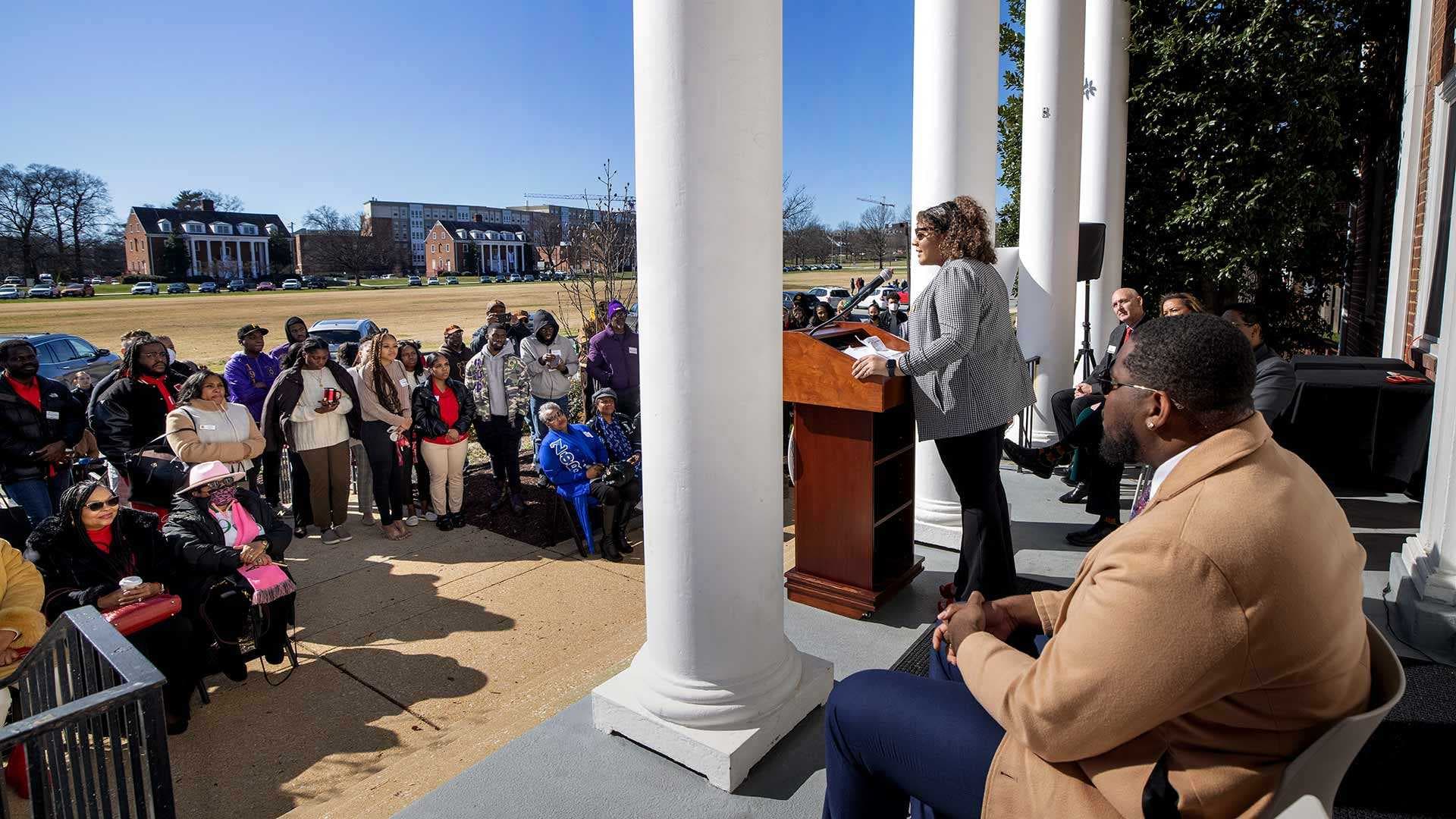 student speaker speaks at the podium at the Agora dedication ceremony