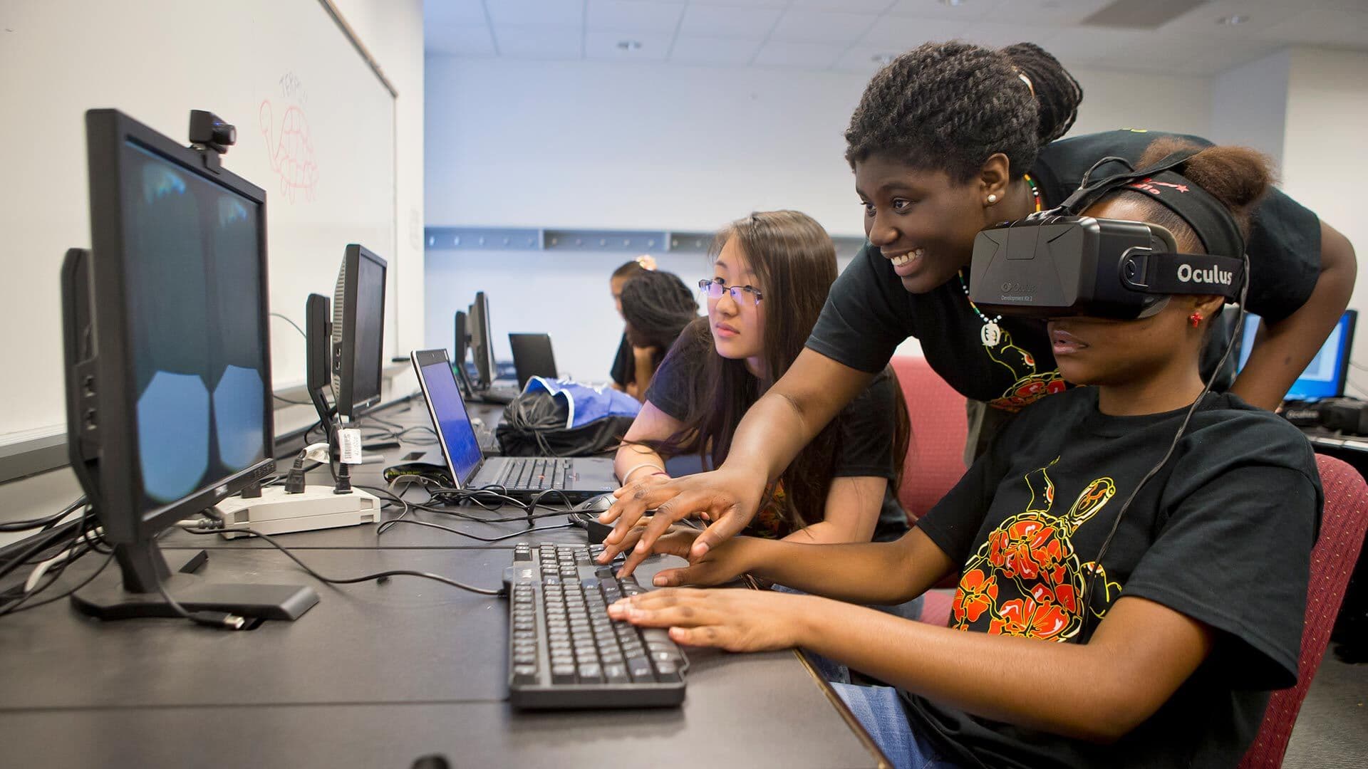 Students at computer with VR headset