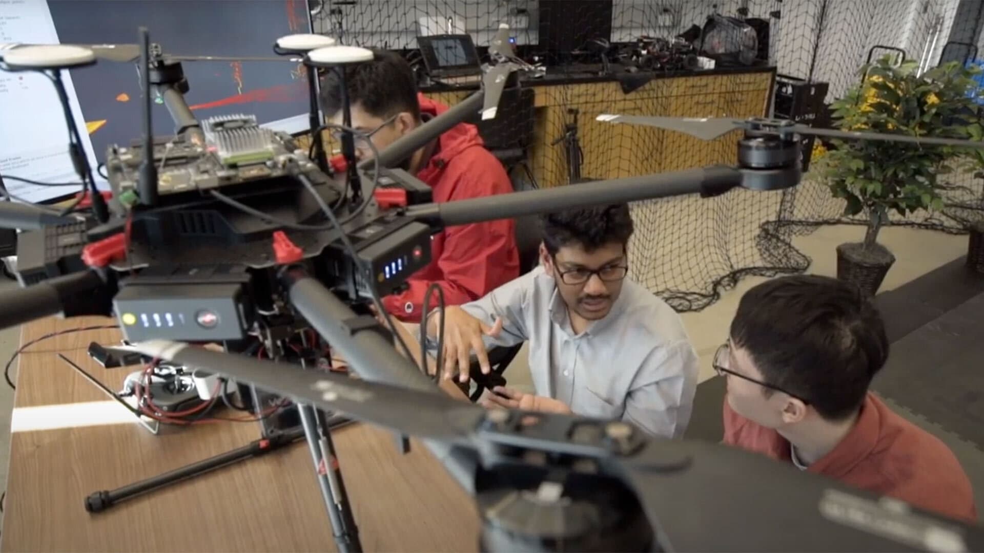 Computer science Assistant Professor Pratap Tokekar (center) works on drones with students in the Brin Family Aerial Robotics lab in the Brendan Iribe Center for Computer Science and Engineering.