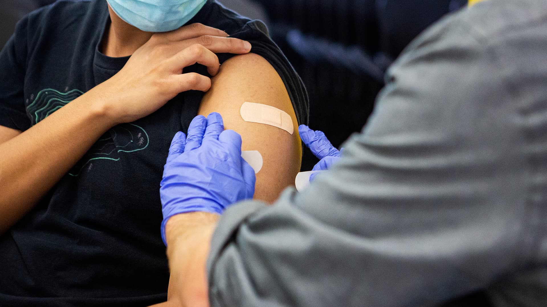 terp at vaccine clinic gets bandage on arm after shot