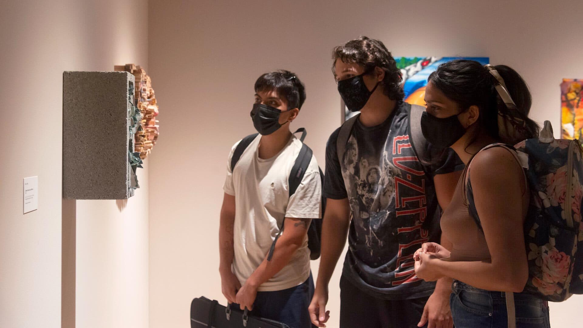 Masked students view artwork in gallery