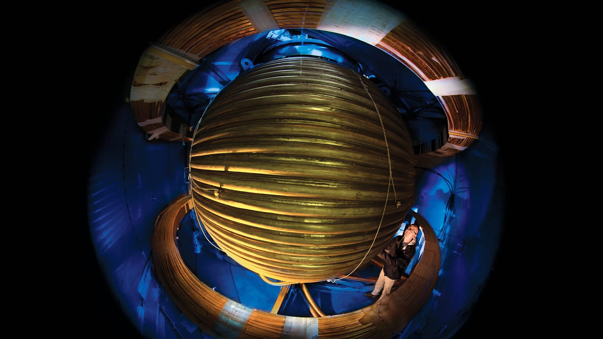 Professor Dan Lathrop examines the 3-meter steel sphere he uses in simulations of the Earth's "geodynamo."