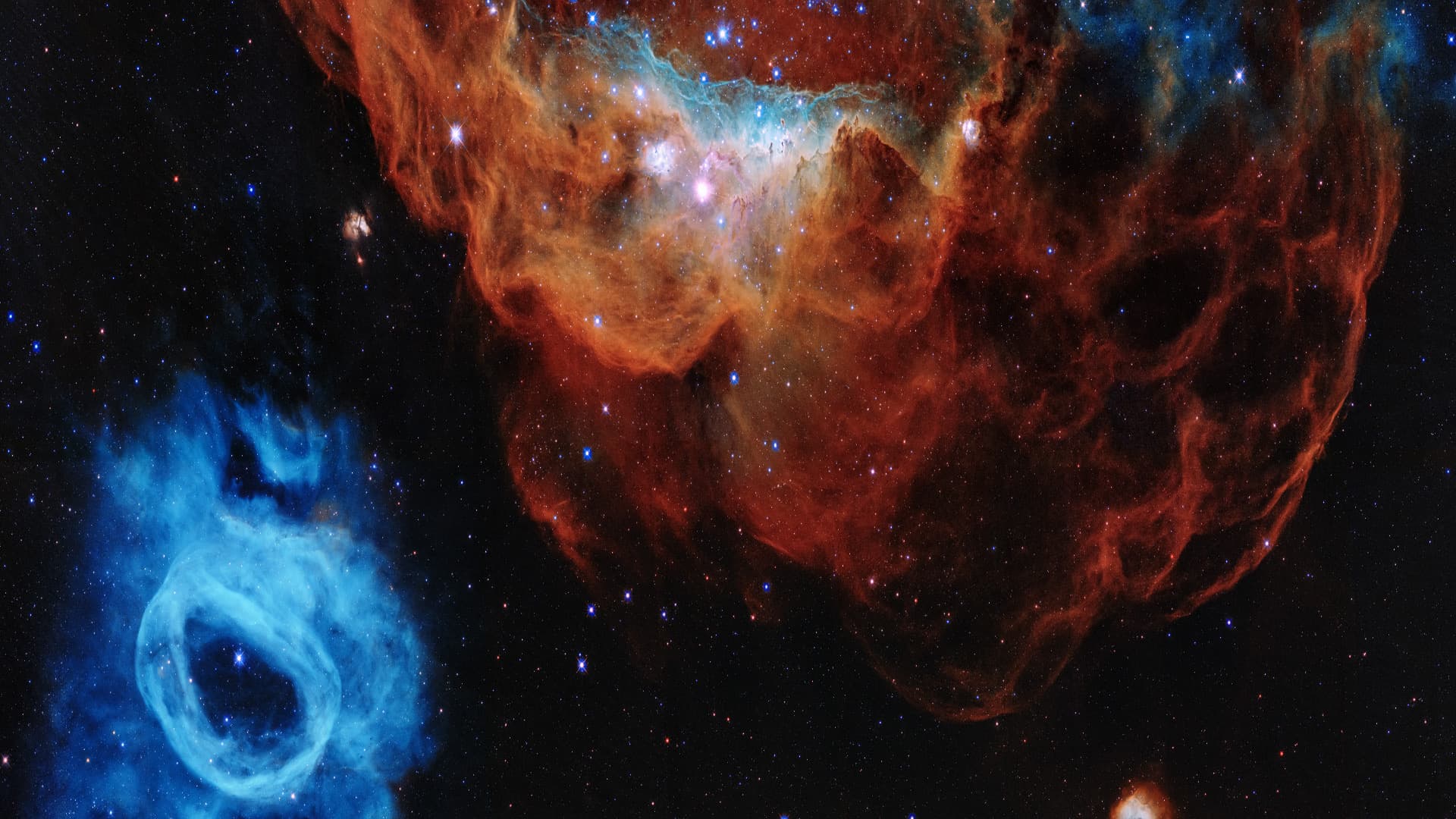 The stellar wind from energetic young stars sculpts the roiling red NGC2014 nebula in the Large Magellanic Cloud
