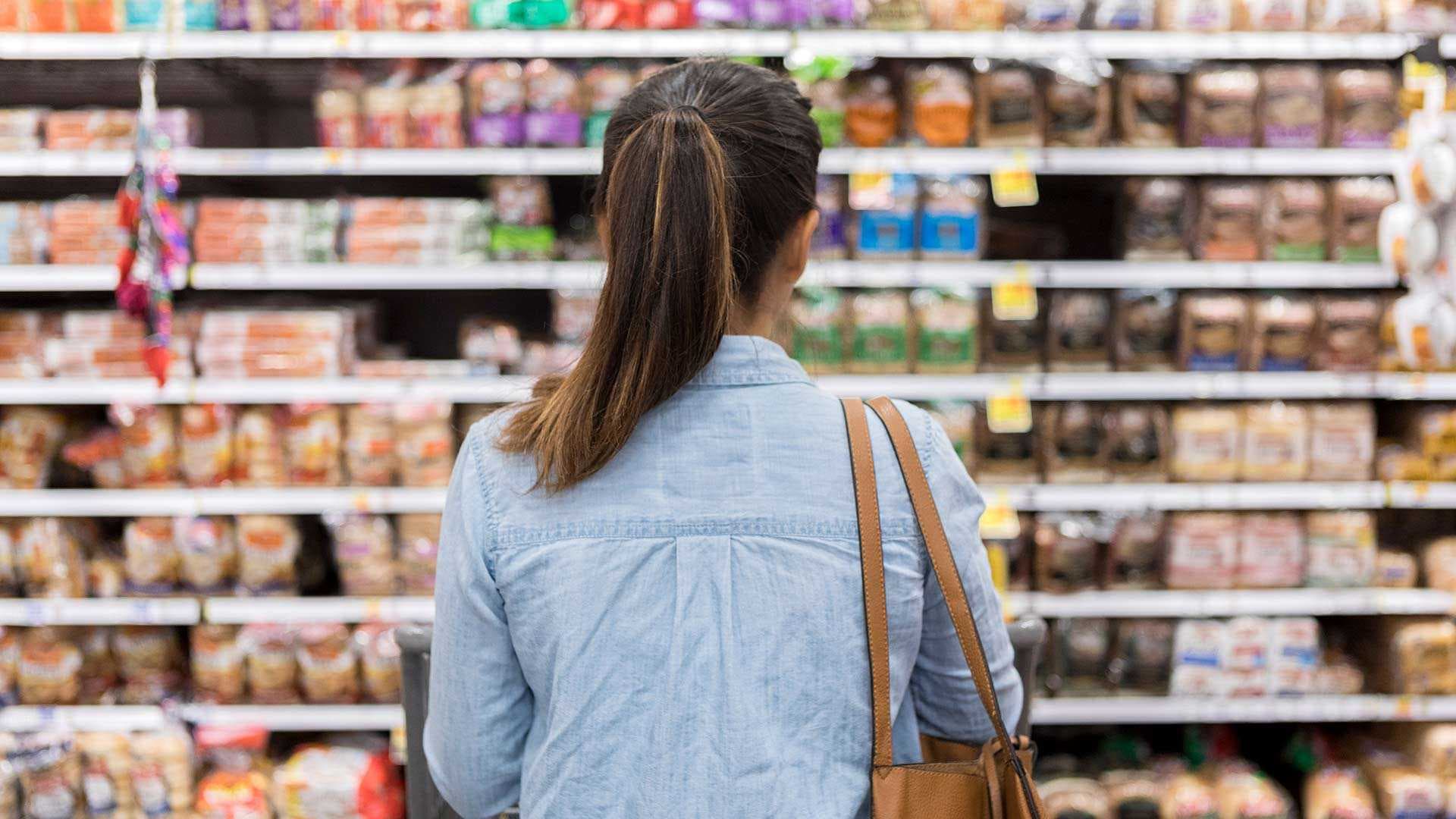 Shopper looks at shelves at grocery store