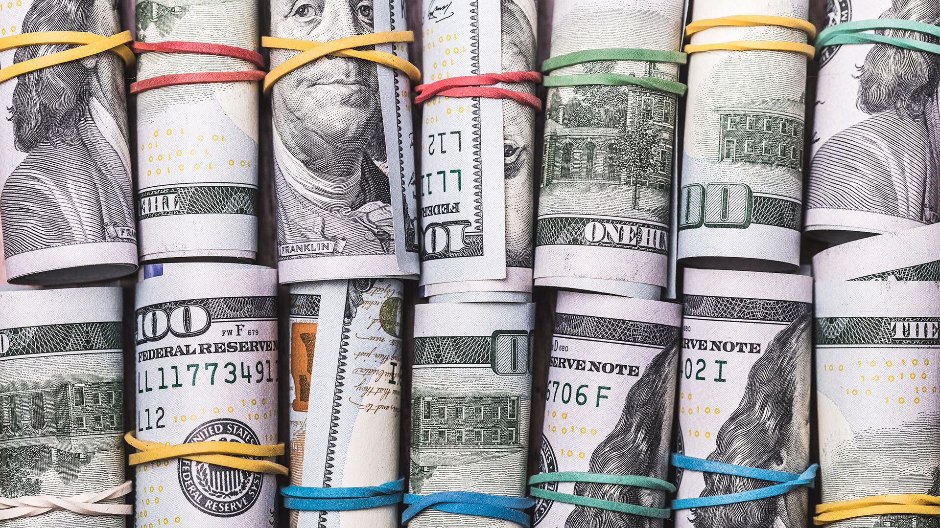 rolls of cash bound with colorful rubber bands
