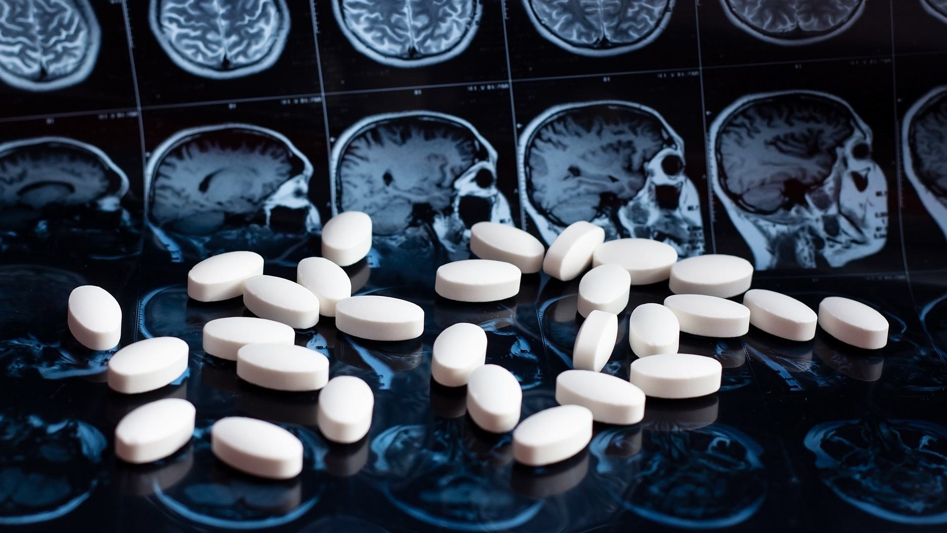 pills with brain images in background