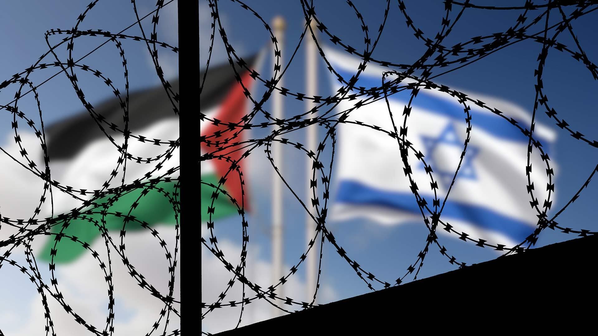 barbed wire fencing with blurry flags for Palestine and Israel in the background