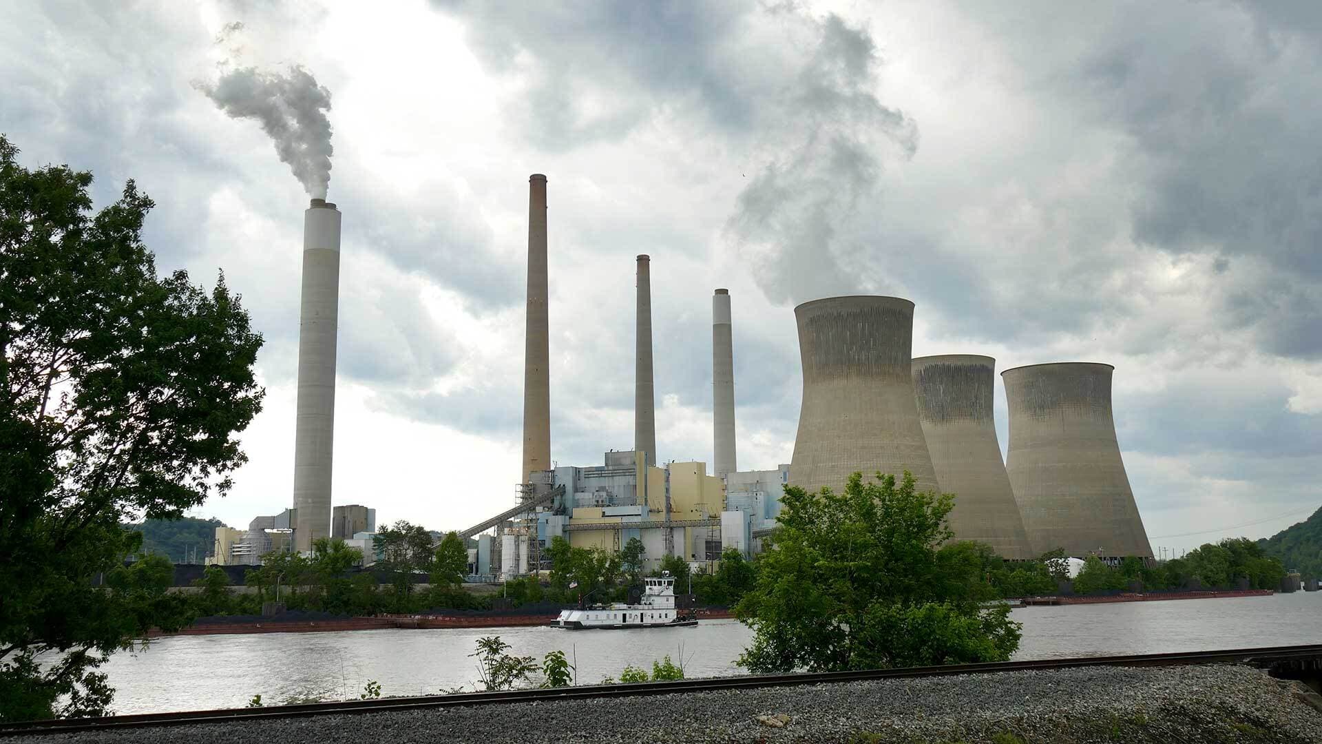 Steam rises from cooling towers at power plant