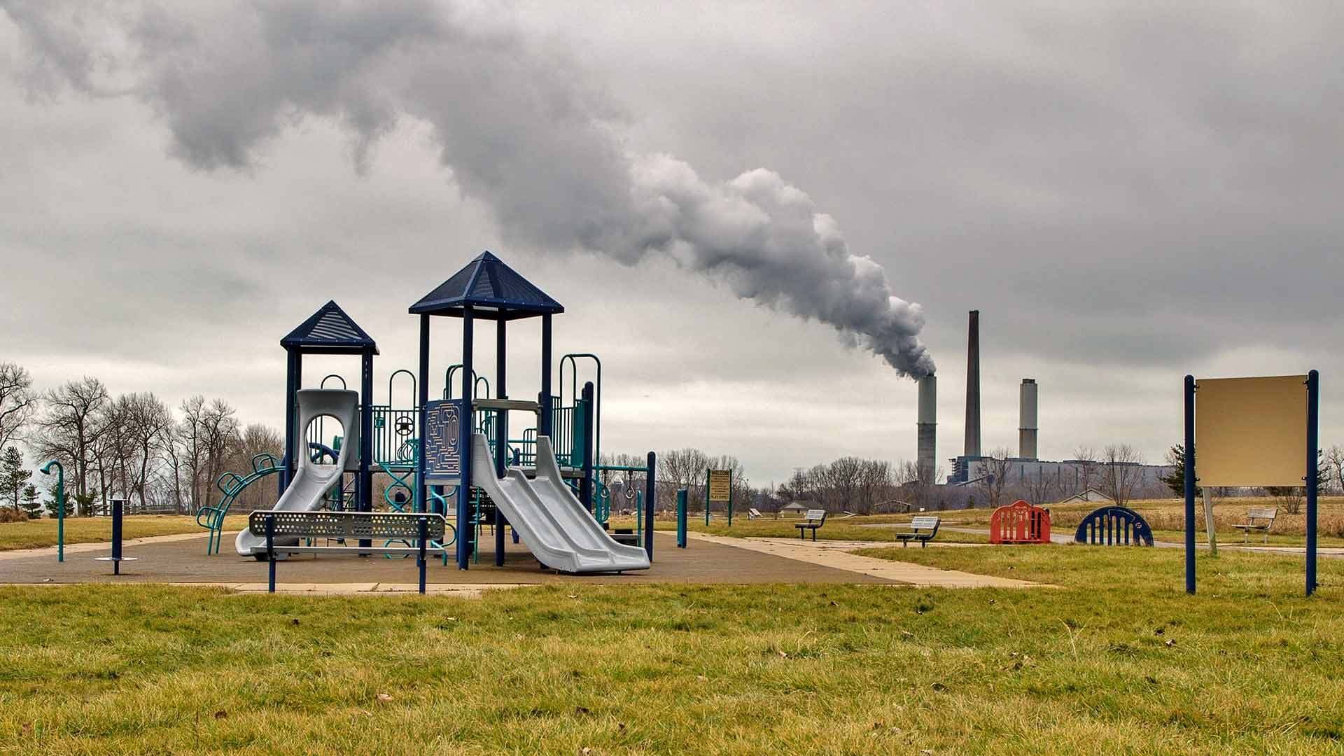playground with smoke stacks in background