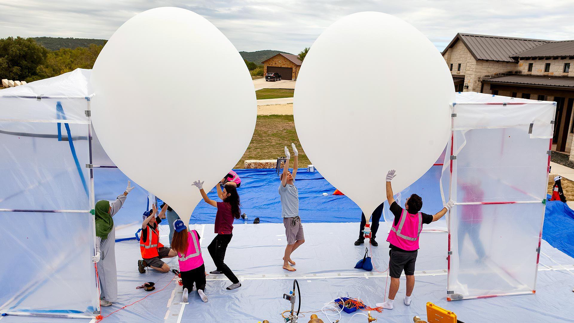 students with two high-altitude weather balloons