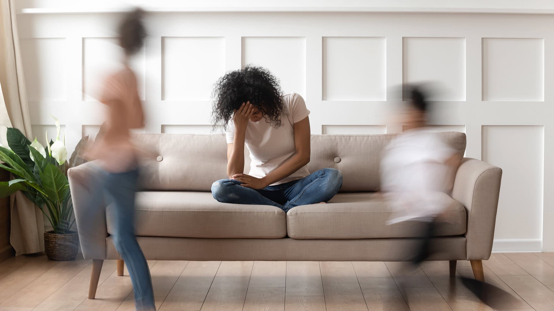 Photo of parent on couch with children in a blur