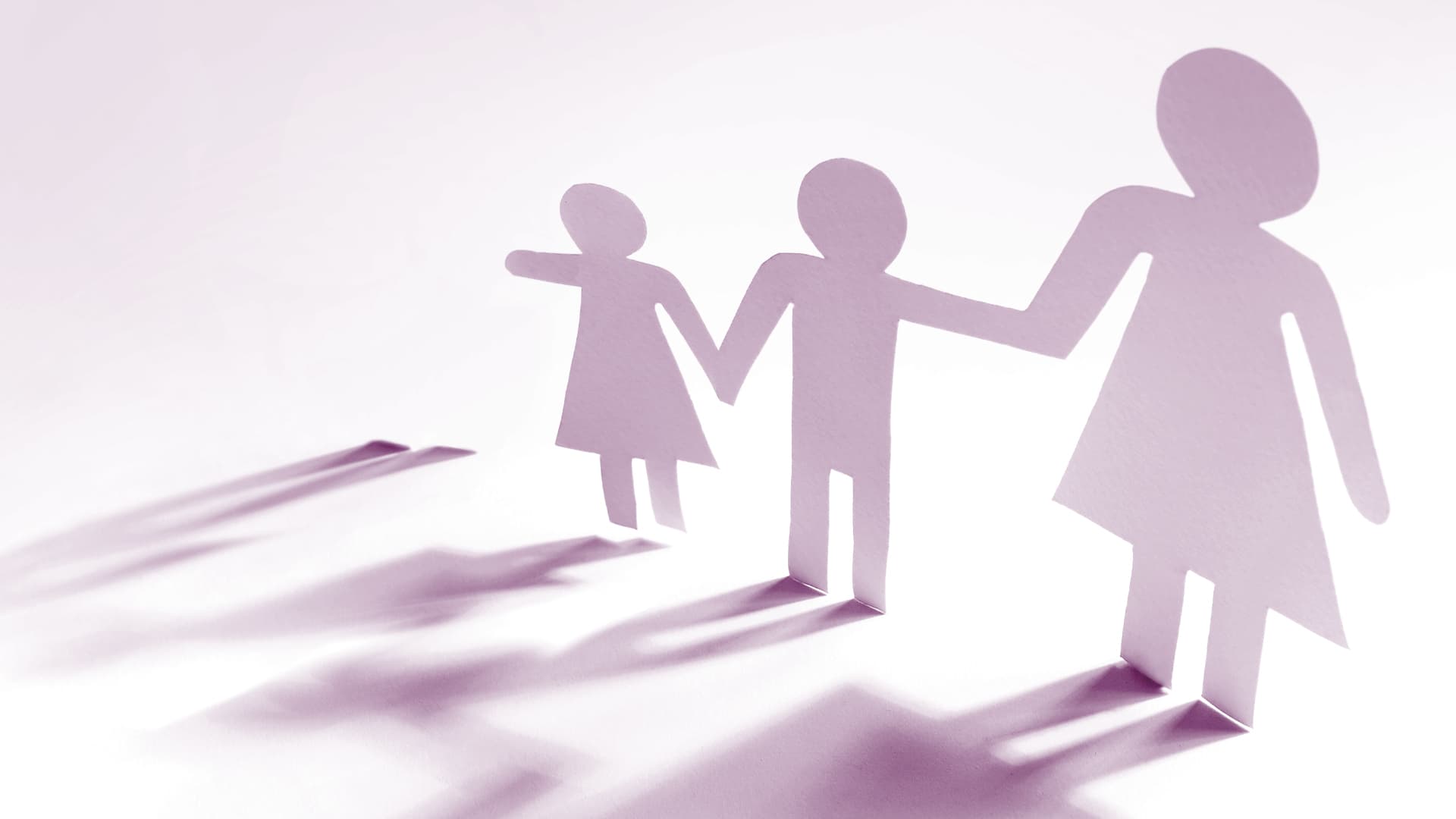 silhouettes of a family of three with a fourth shadow