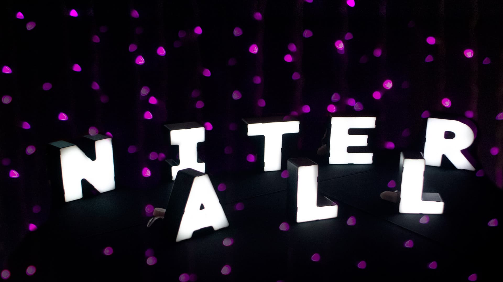 All Niter written on black background with pink polka dots