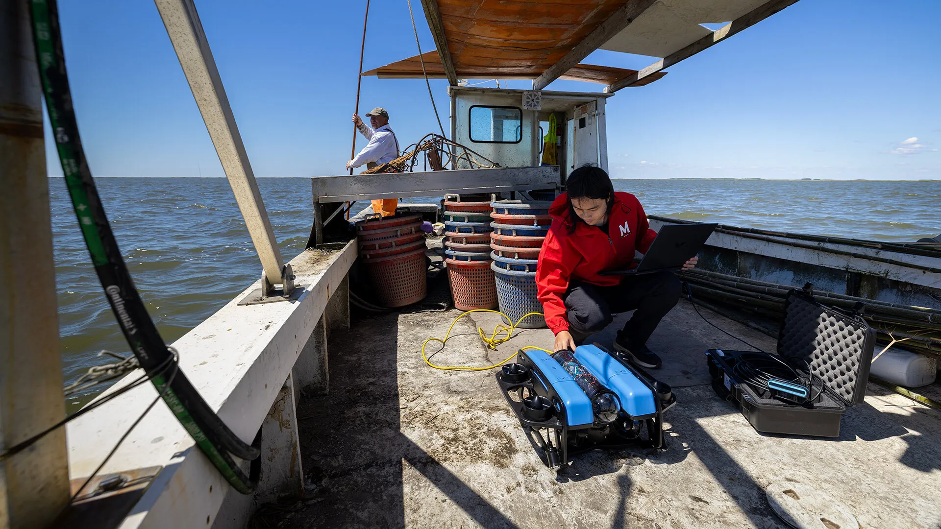 researcher prepares robot on boat