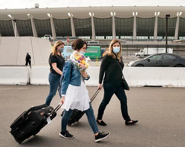 Nicole Carroll leads Hosseini out of Dulles International Airport