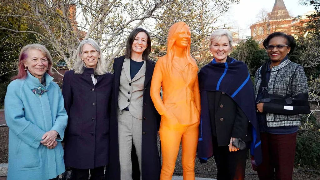 Mercedes Taylor with her orange statue, part of “#IfThenSheCan—The Exhibit”