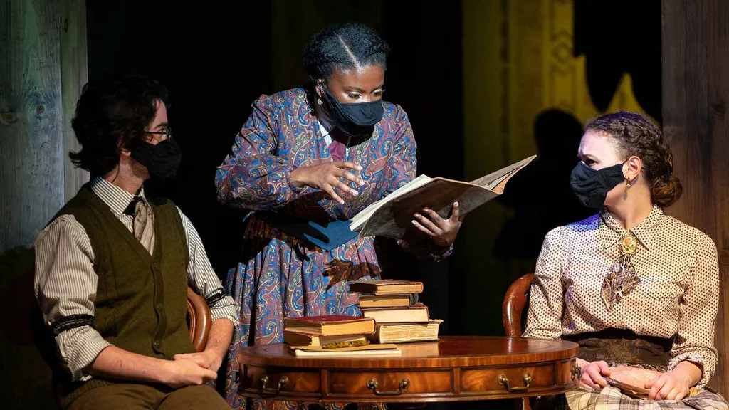 March (Leilani Clendenin ’22) shares her writing with Professor Bhaer (Jake Schwartz ’22) and Mrs. Kirk (Katie Rees ’23) in "Little Women"