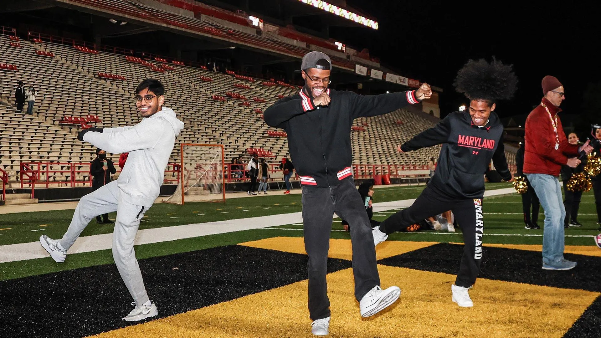 students dance in end zone at SECU stadium