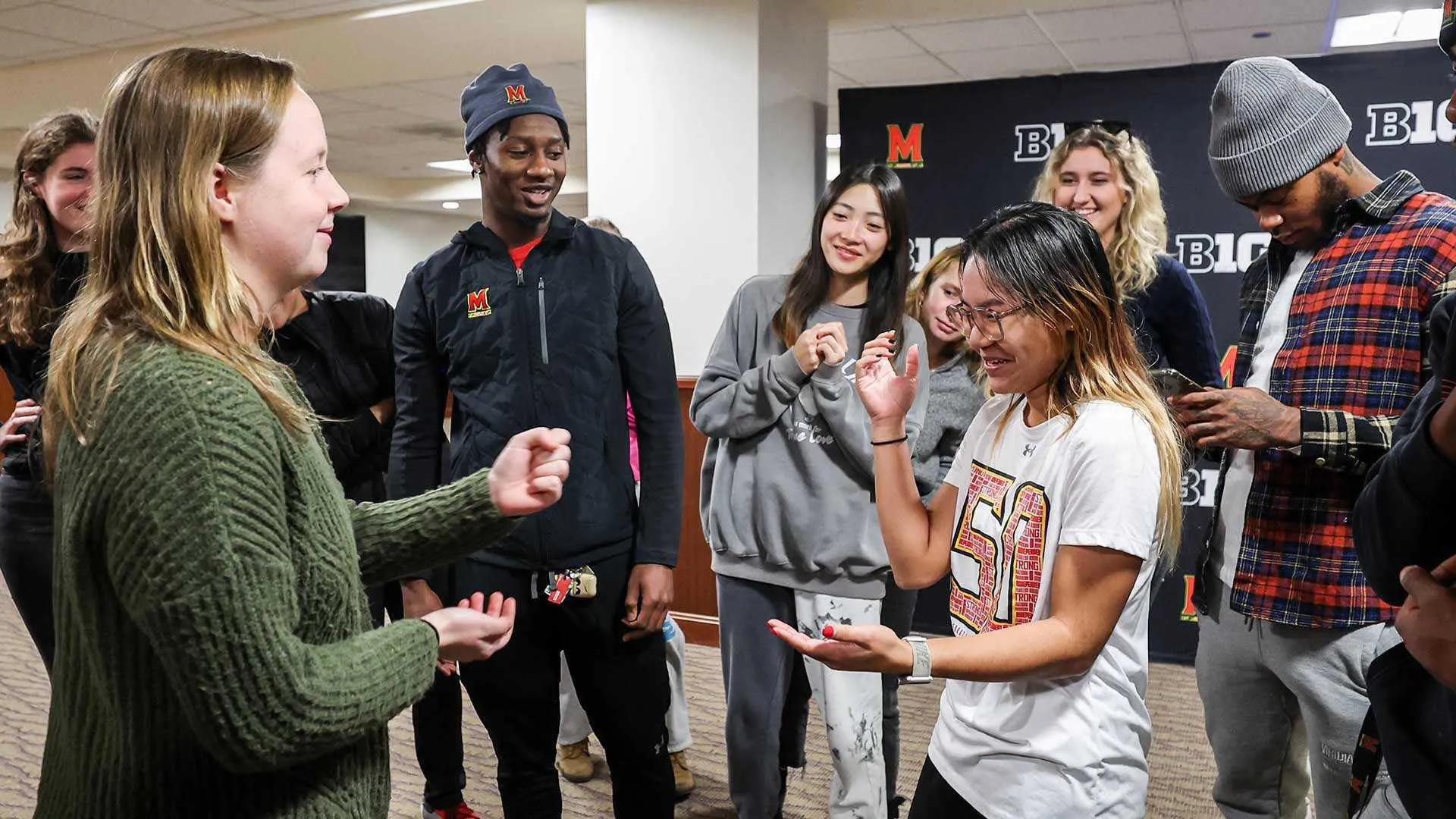 Students playing games with their hands while standing