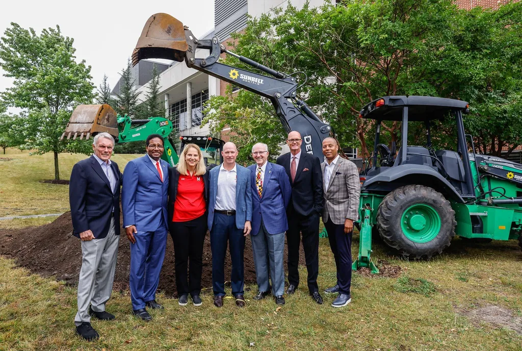 seven people line up in front of excavator