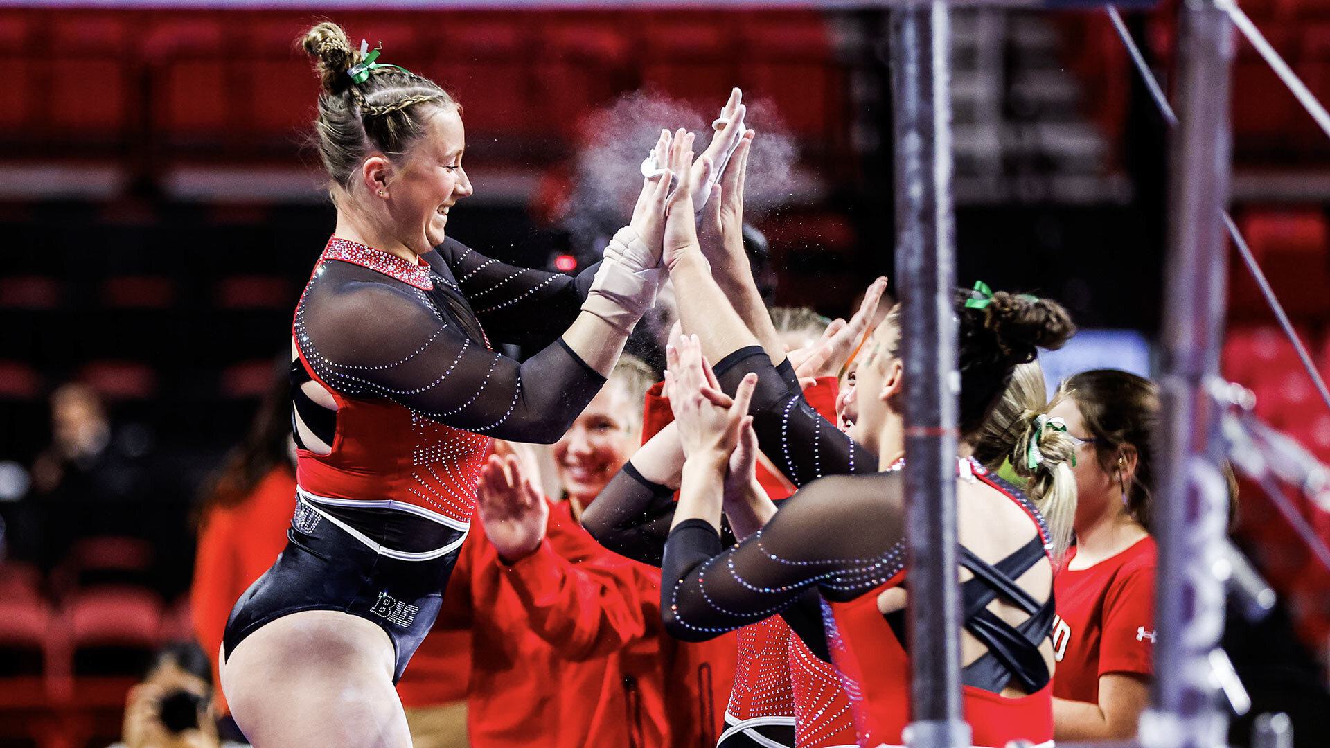 gymnastics team high fives