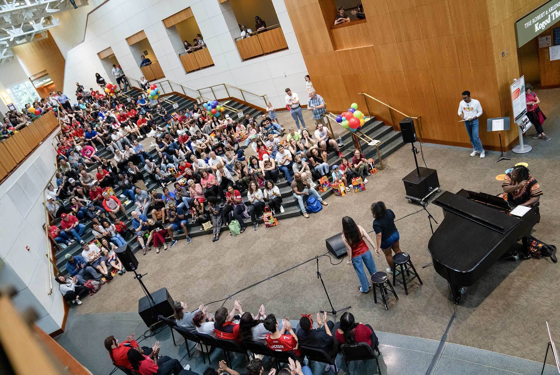 overhead image of musicians and spectators in giant room