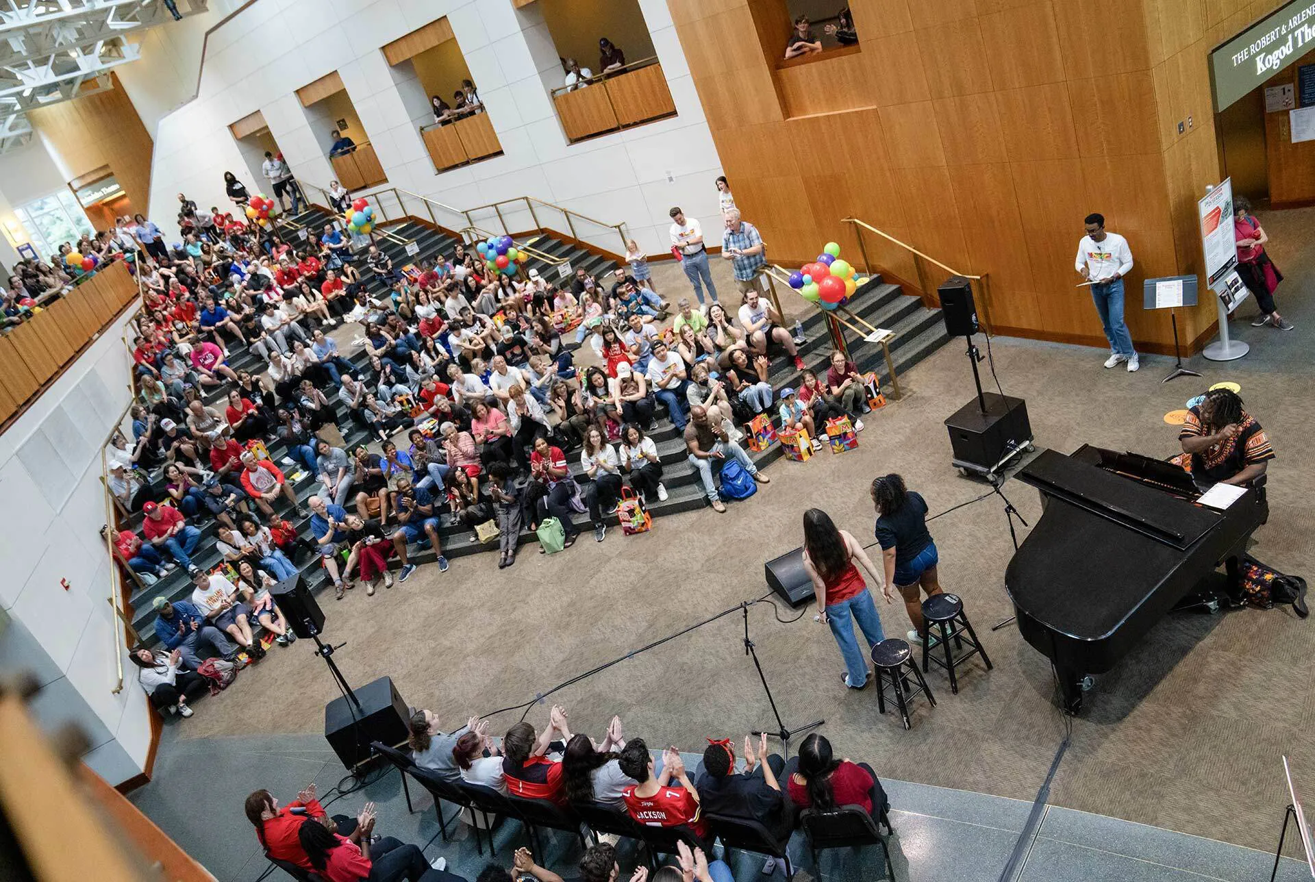overhead image of musicians and spectators in giant room