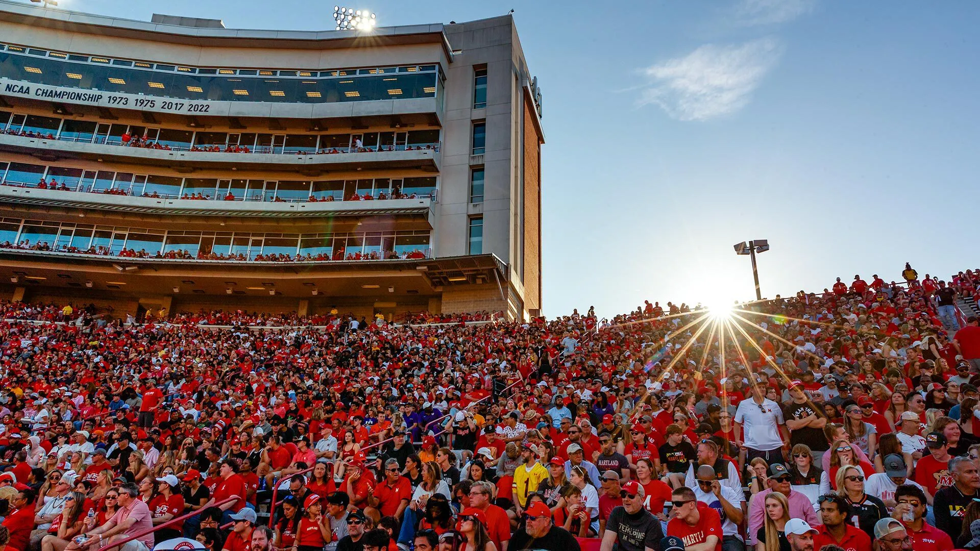 Fans in red pack a football stadium