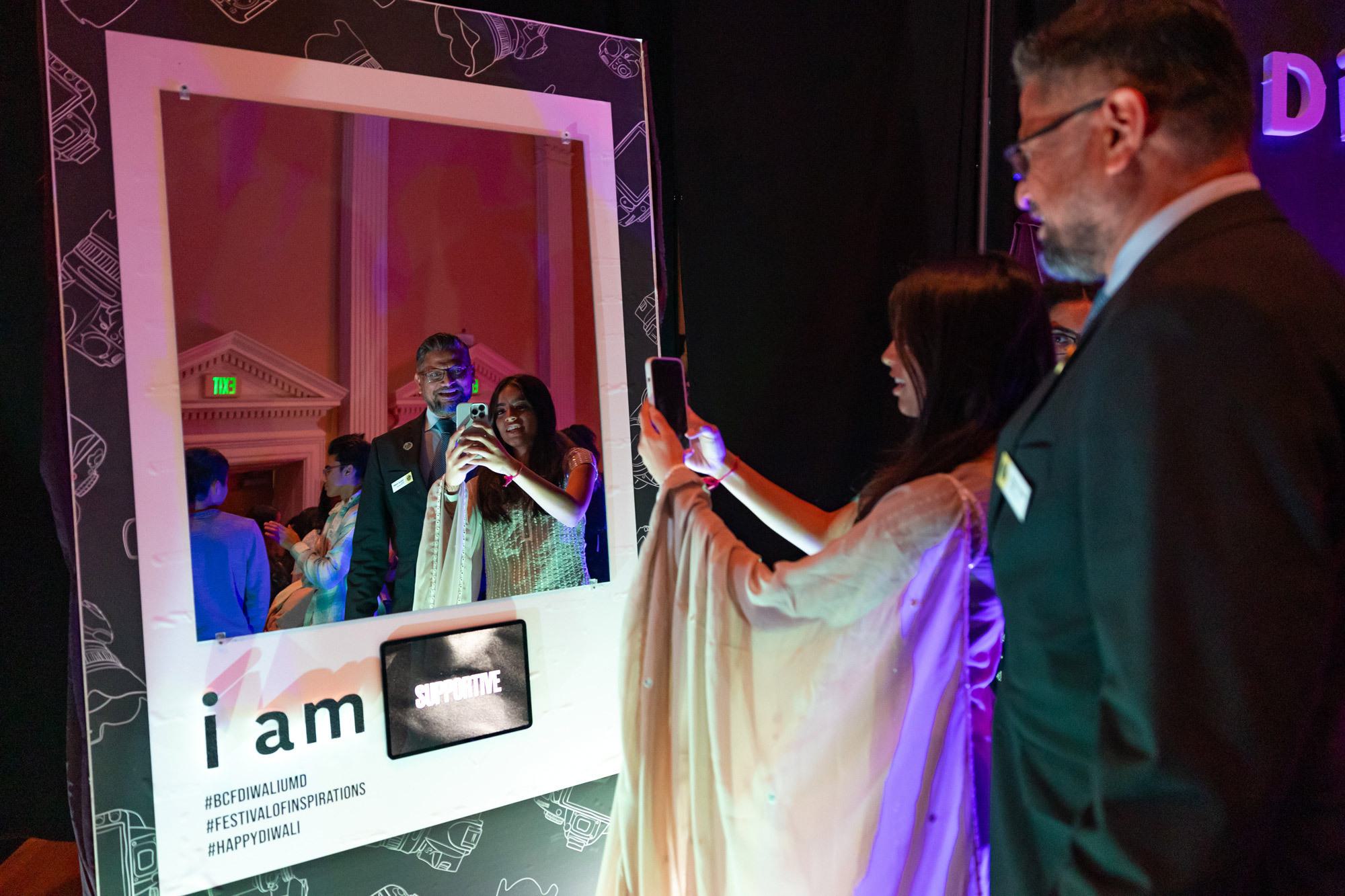 A couple takes a photo in a mirror