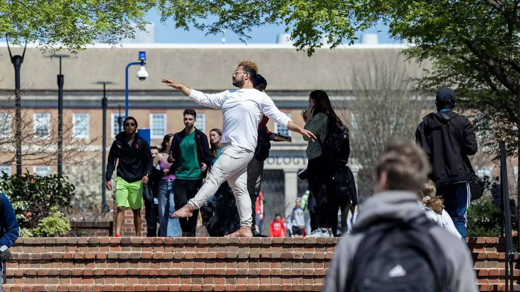 Student poses at top of stairs