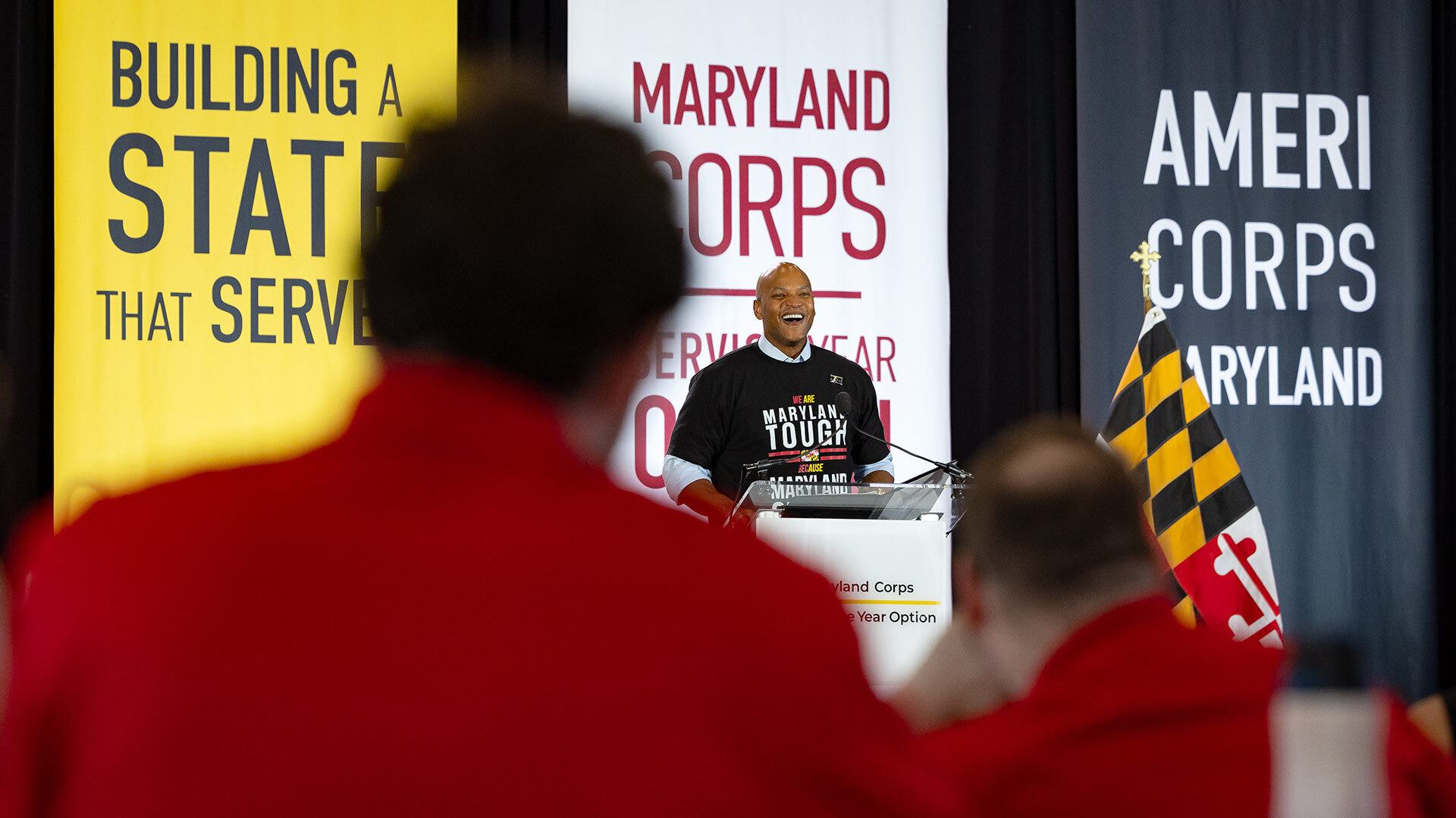 person speaks in front of audience at podium