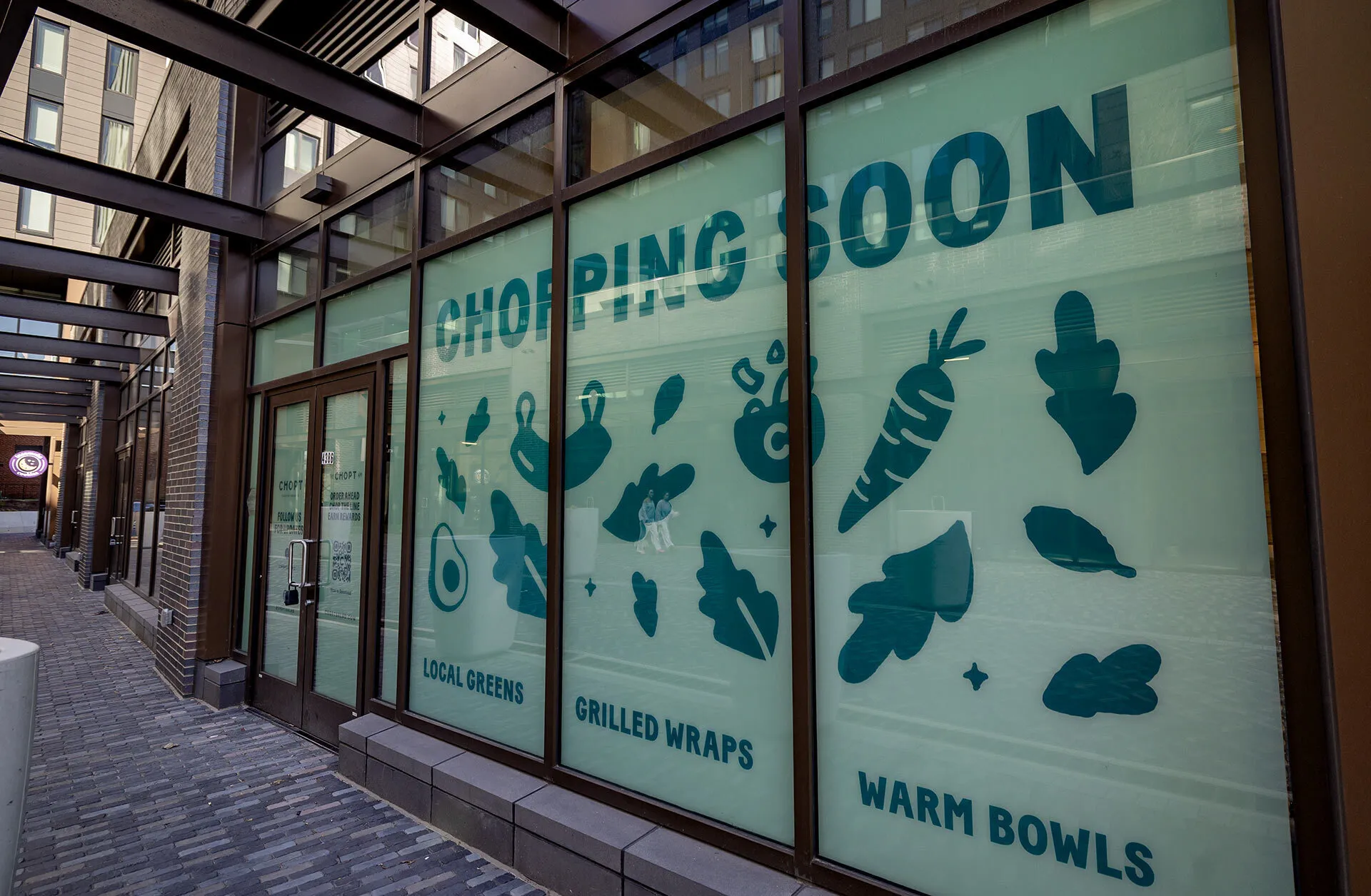 exterior of upcoming Chopt restaurant with "Chopping soon" sign