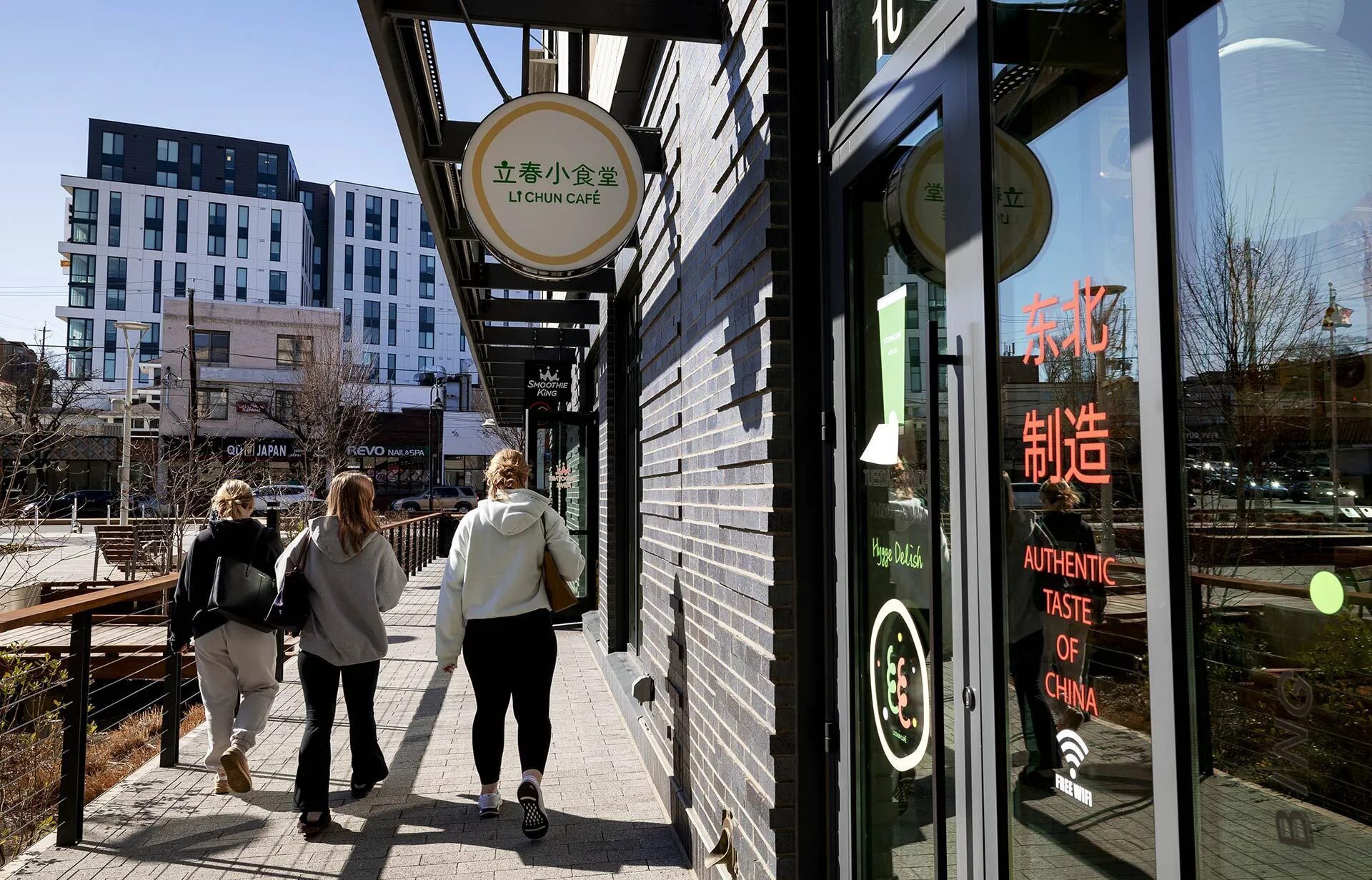 people walk by Li Chun Cafe