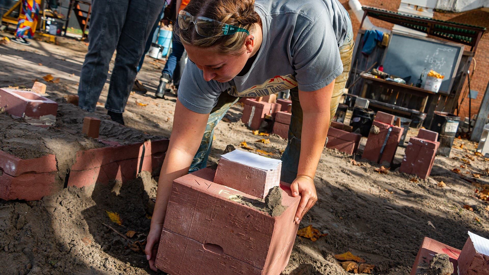 student picks up mold