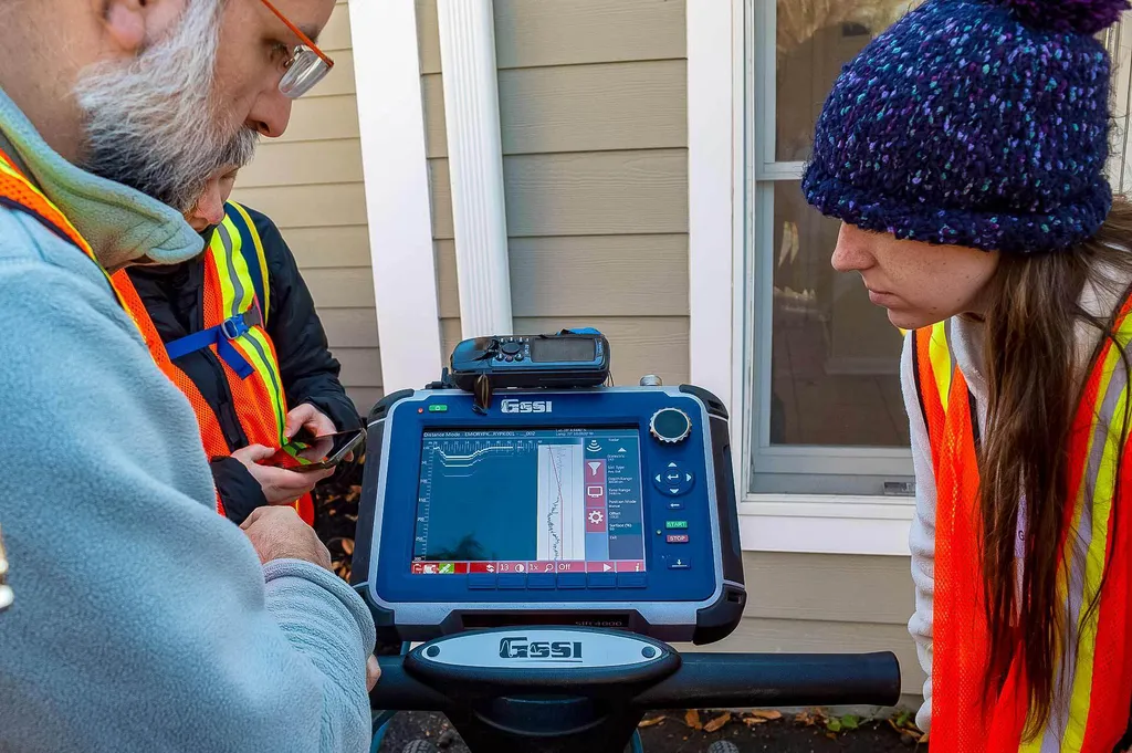 Professor and students look at ground penetrating radar