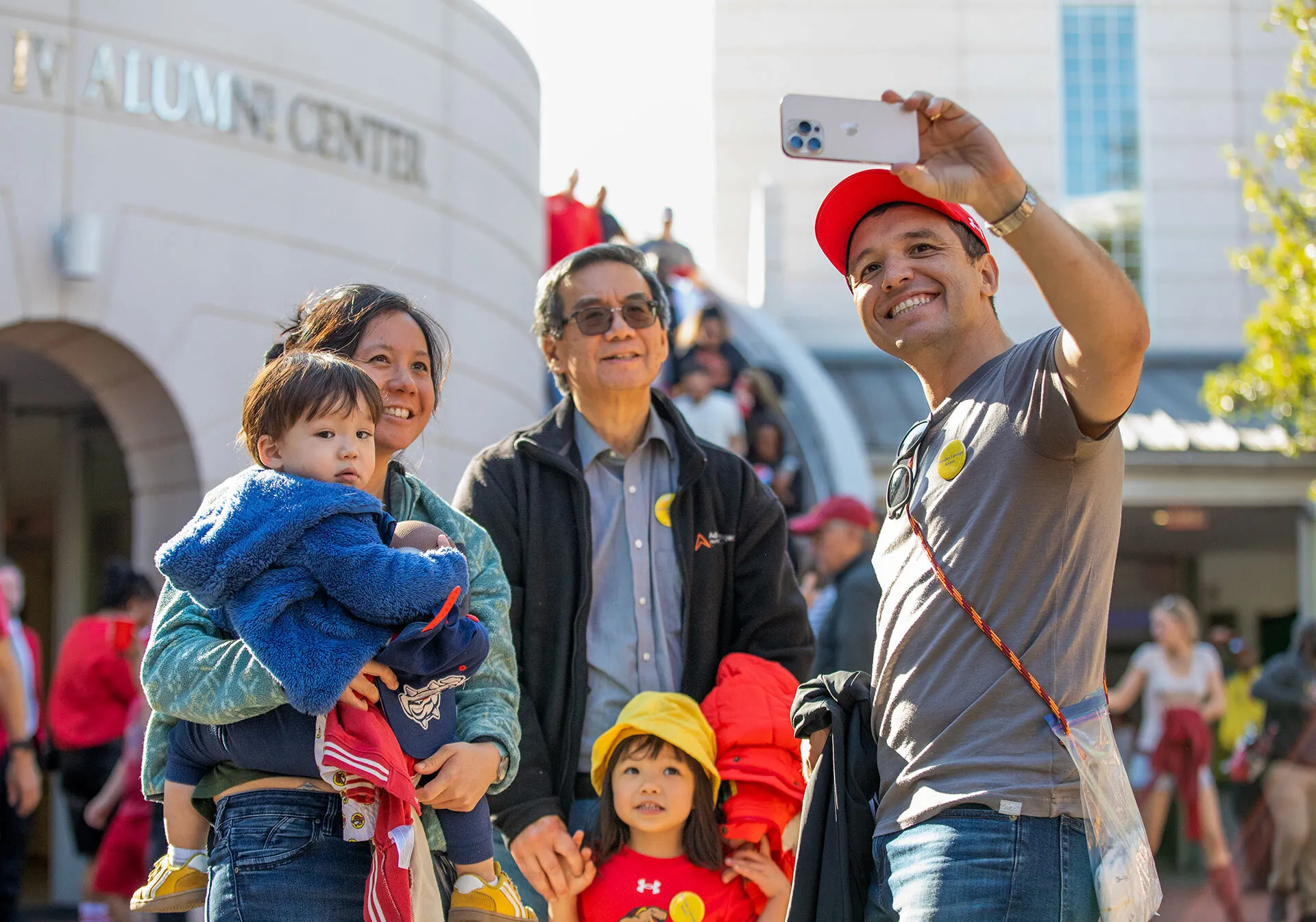 family takes selfie in front of Riggs Alumni Center
