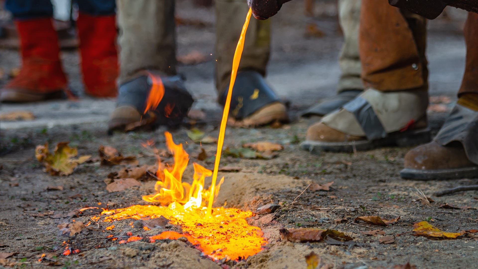 A stream of iron is poured into a trench