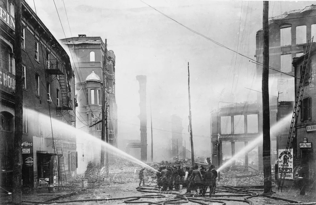 firefighters spray buildings with hoses