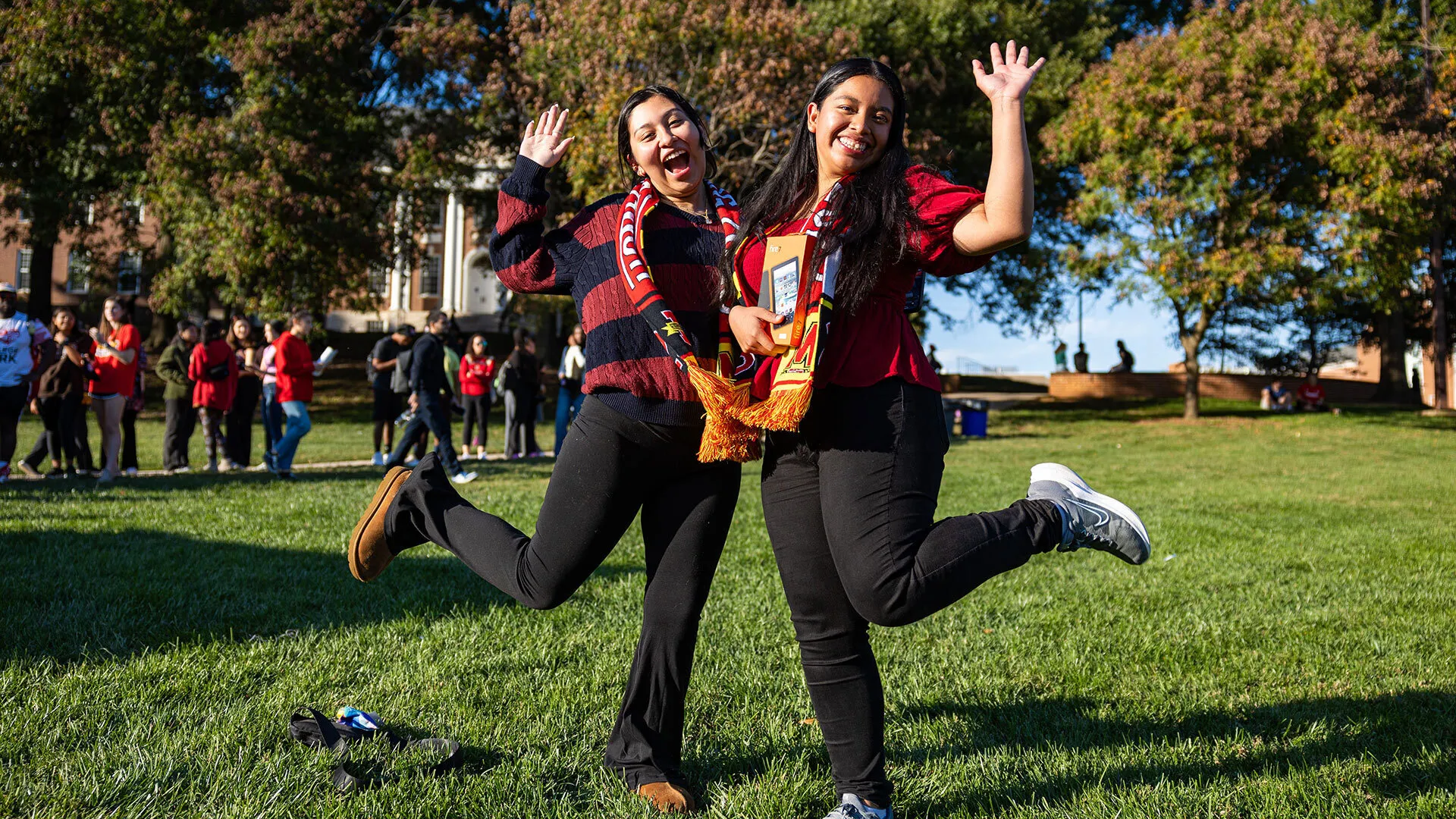 two people hug and pose for the camera outdoors