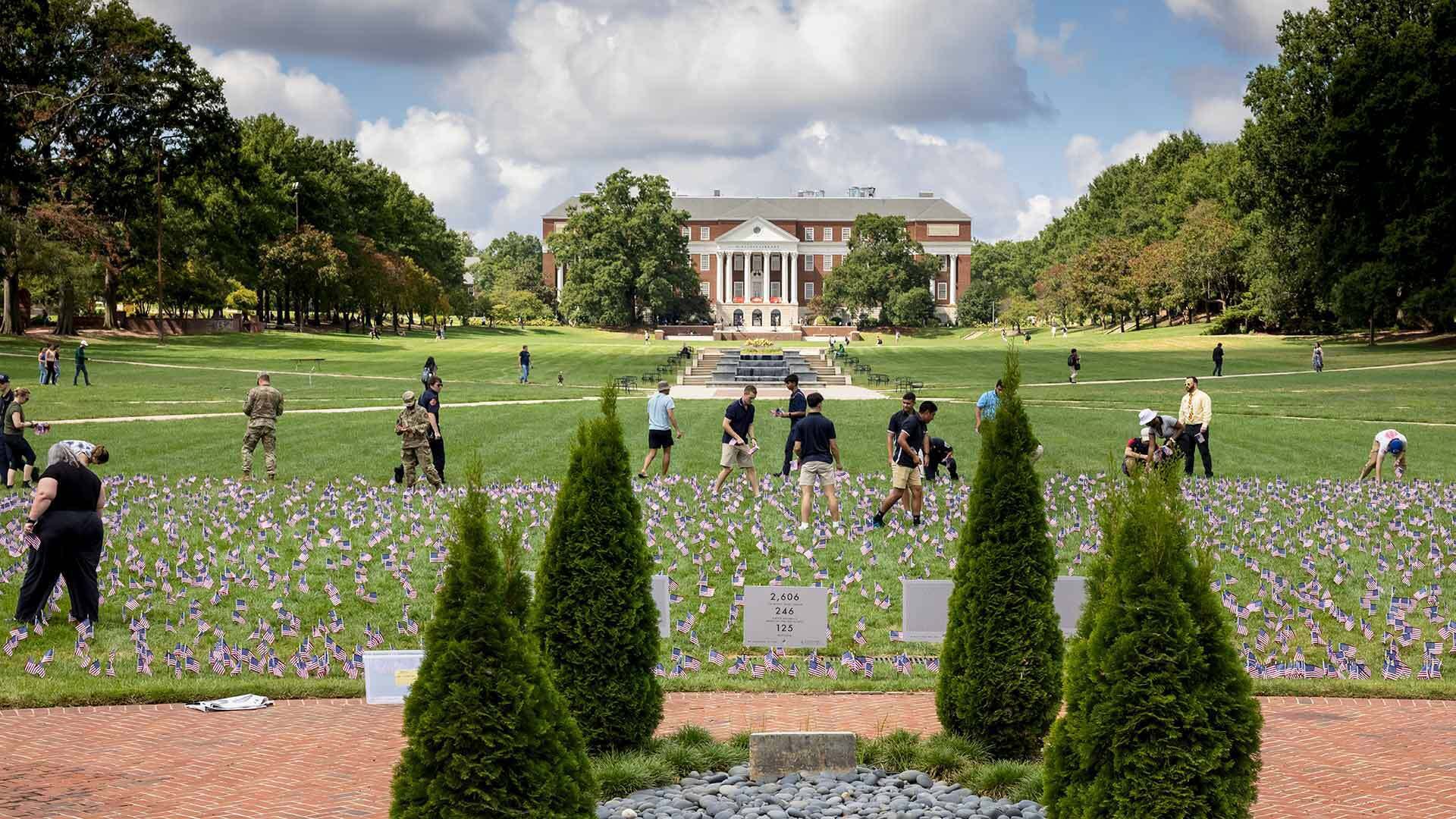 people plant American flags on McKeldin Mall