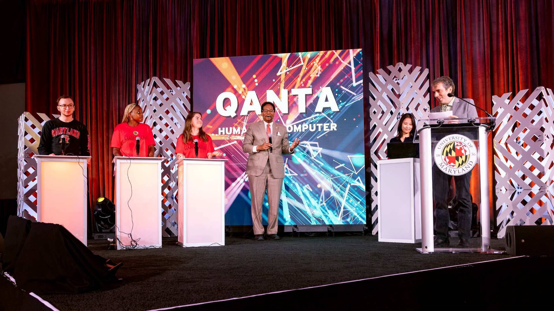 Pines and students on stage for QANTA game at AIM event