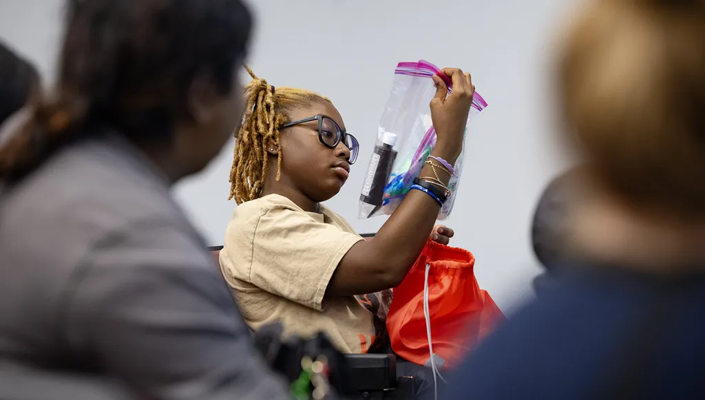 student looks over bag of items for show dog care