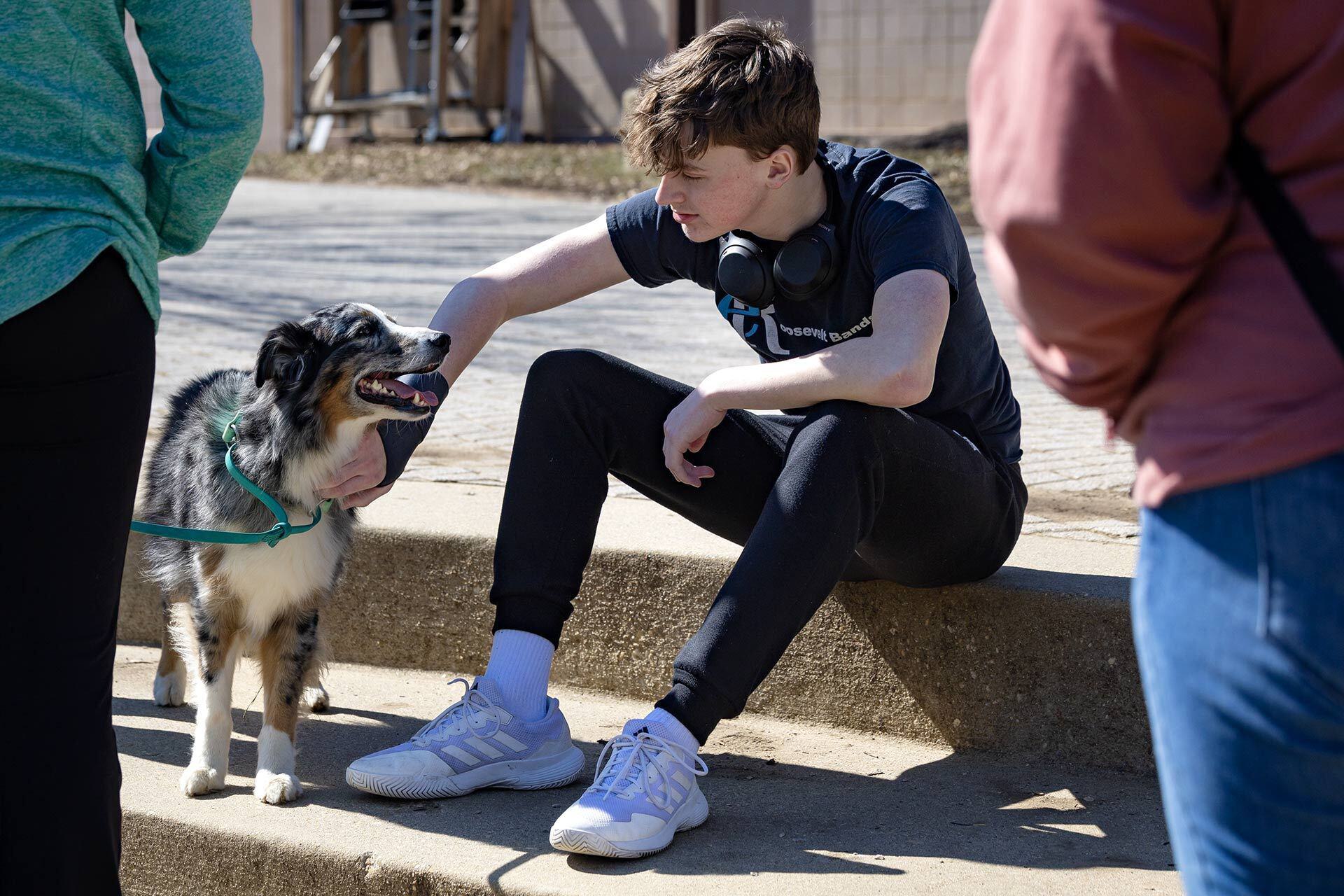 student pets dog