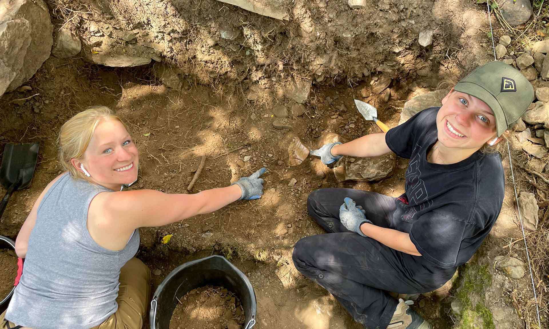 two students point to artifact