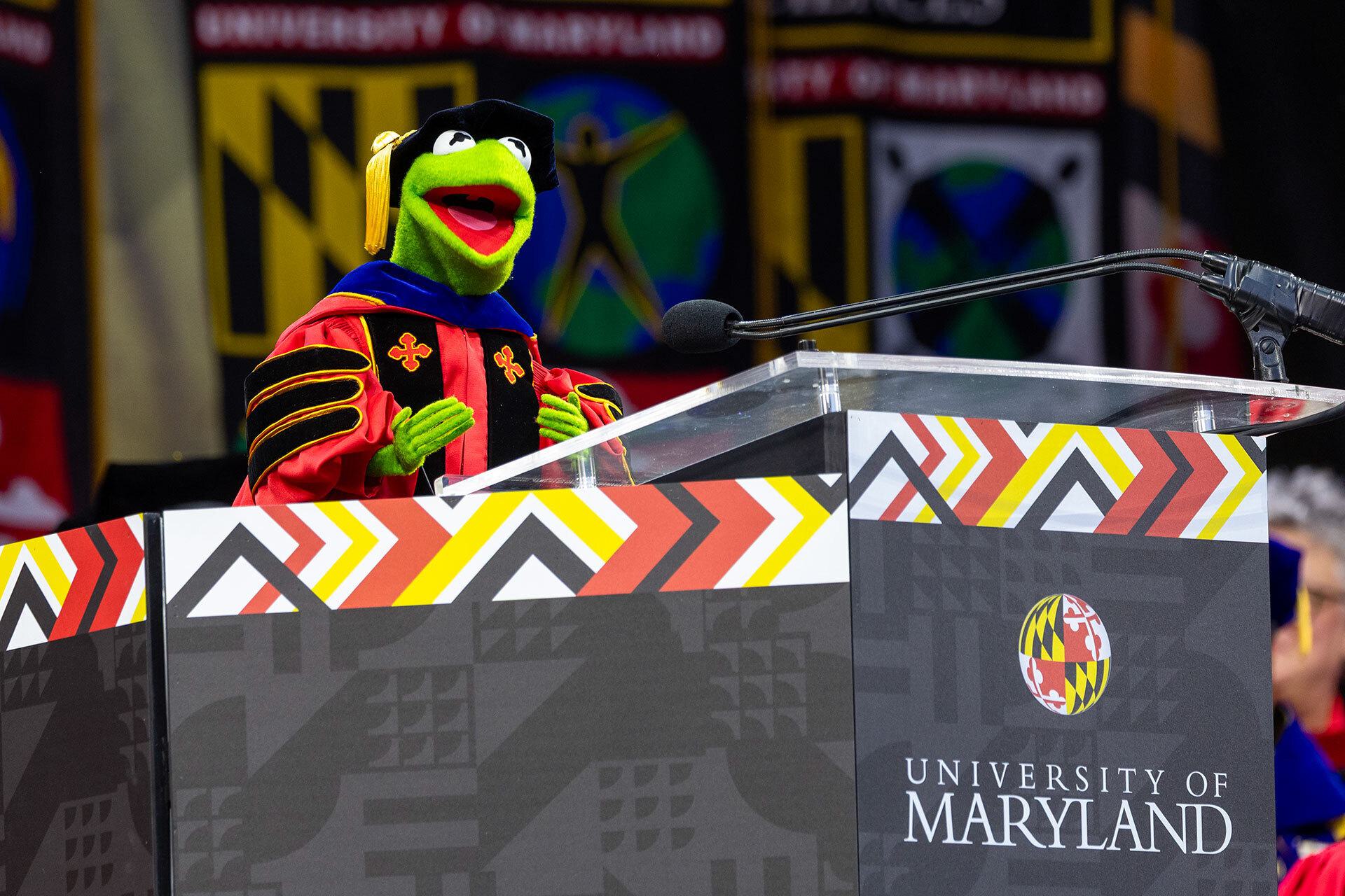 Kermit the Frog wears regalia at podium