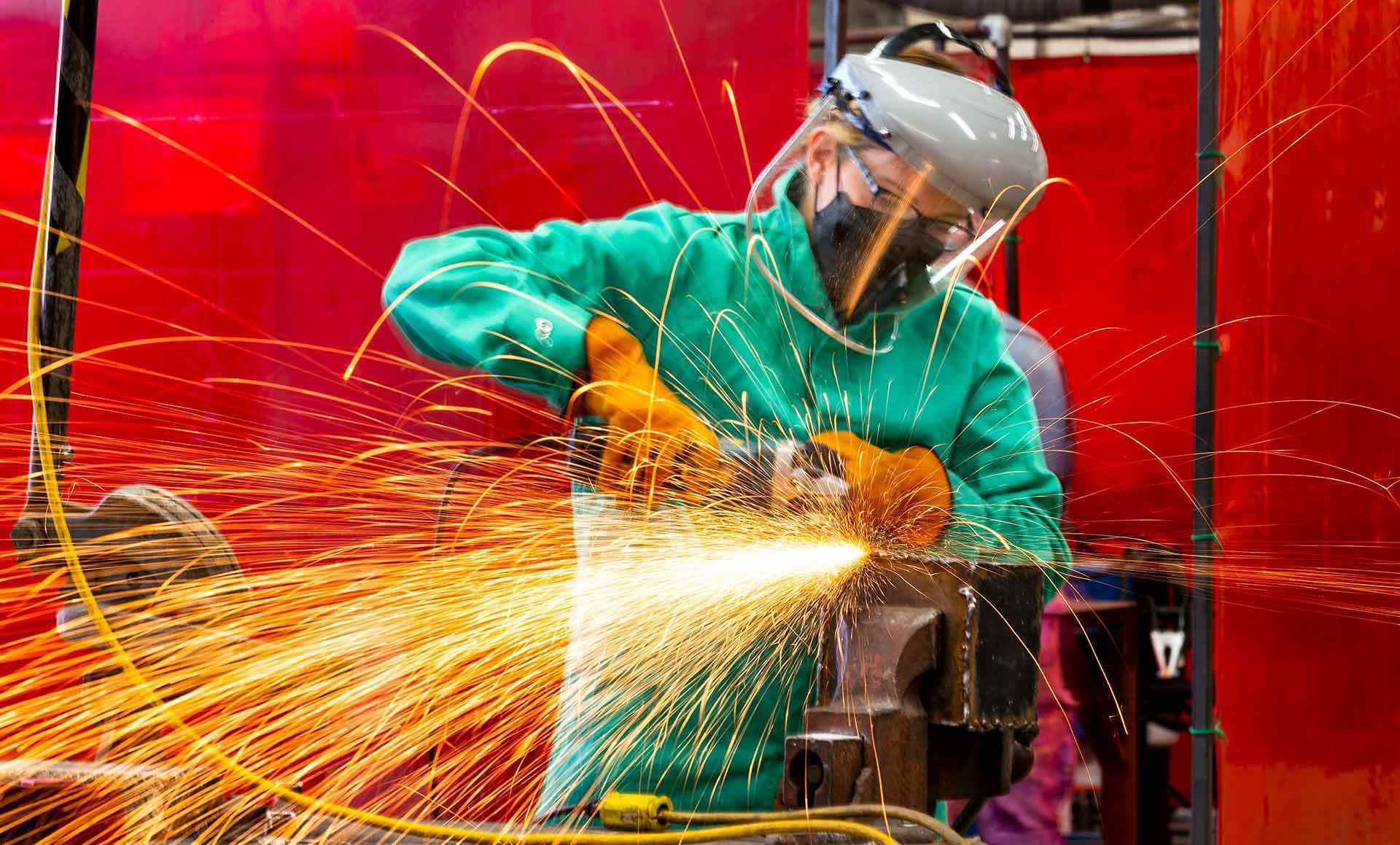 sparks fly as student works a piece of metal