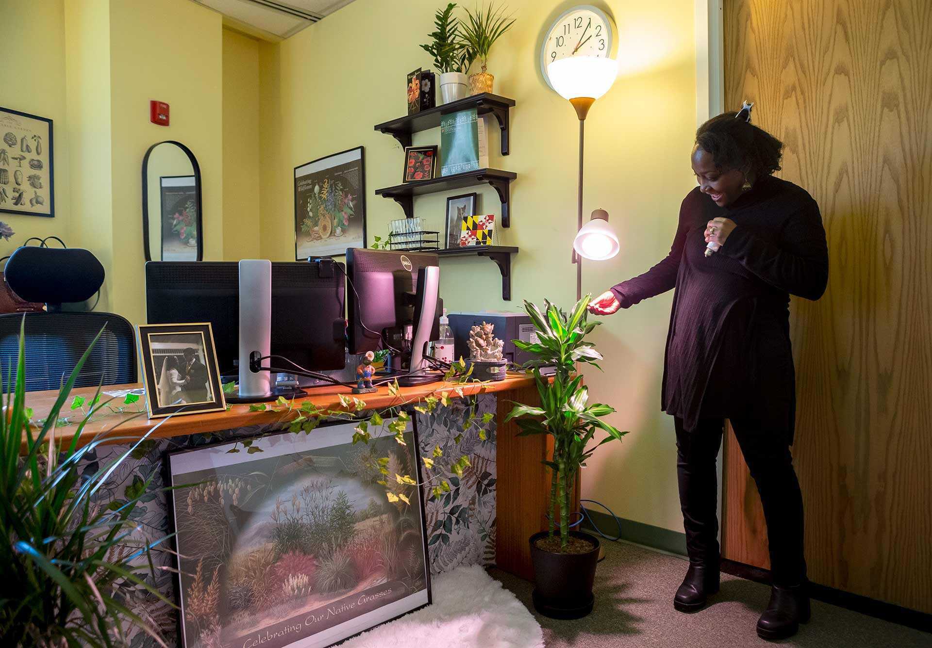Flores looks at plant under light